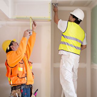 men working for loft conversion of room