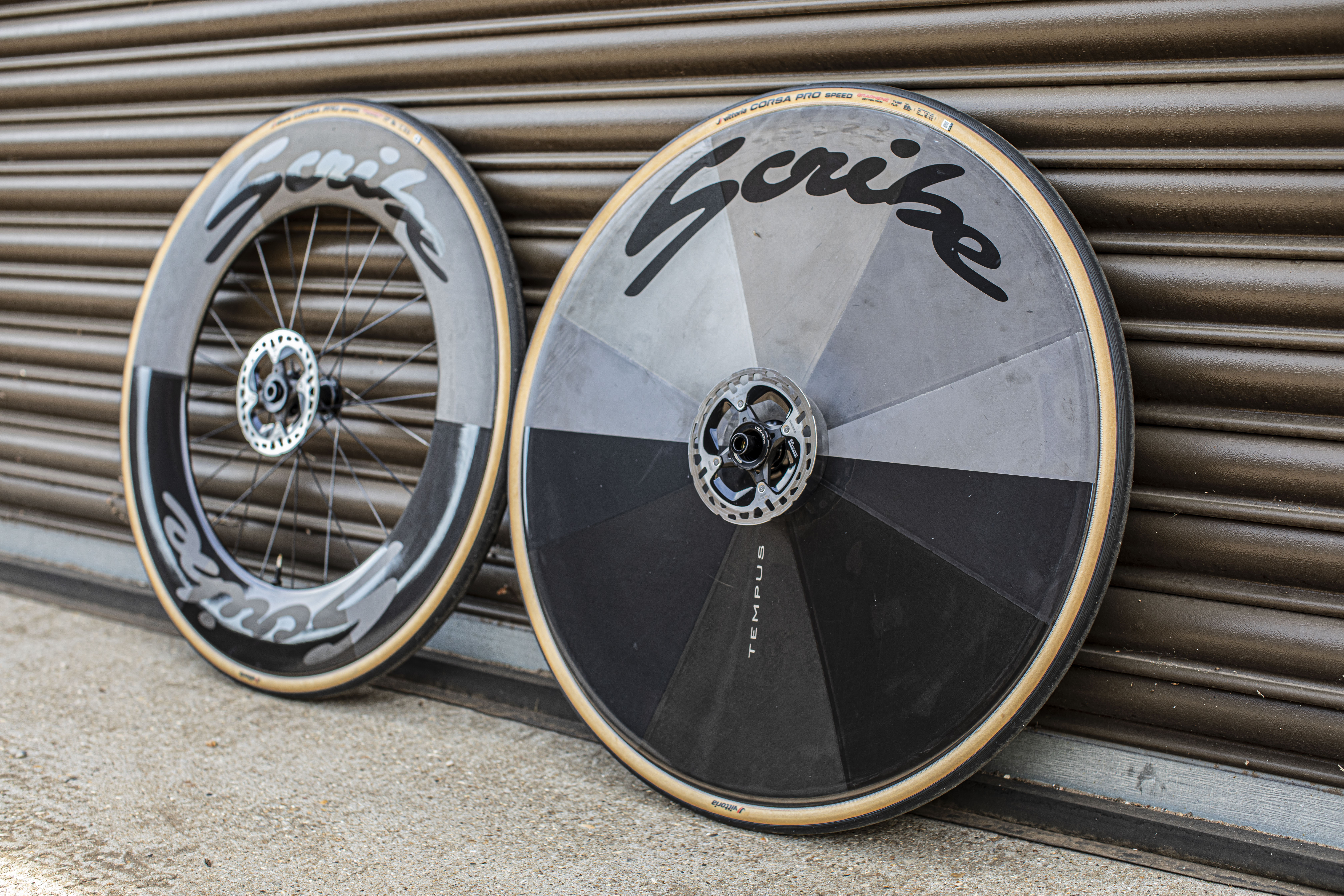Scribe Tempus Disc/100 wheelset leaning against a corrugated warehouse door