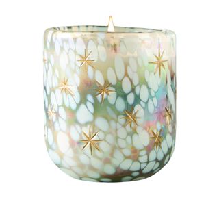 Vanilla scented candle in a patterned glass contained with gold stars