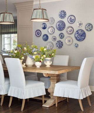 white and blue dining room with vintage blue and white plate wall