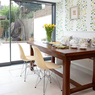 dinning area with tea cups and wallpaper on wall
