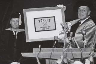 Returning to his alma mater to receive an honorary doctorate in January 1970, Neil Armstrong presents Purdue University president Frederick Hovde with a Purdue Centennial flag that was carried to the moon on the Apollo 11 mission.