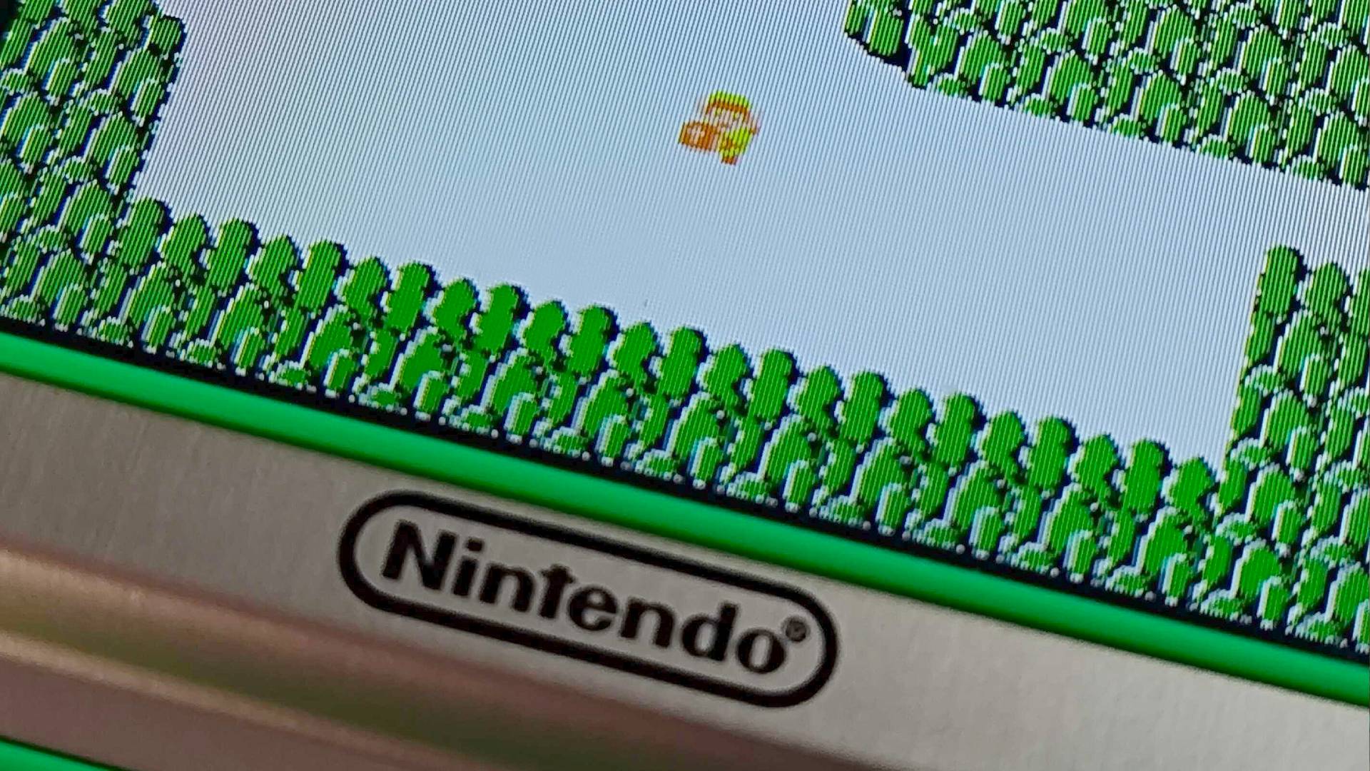 Close up of Zelda Game and Watch screen featuring tiny Link and Nintendo logo on bezel.