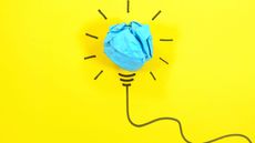 drawn lightbulb with blue paper on a yellow background
