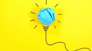 drawn lightbulb with blue paper on a yellow background