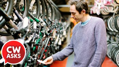 CW Asks - a man shopping for a bicycle looking at a pricetag