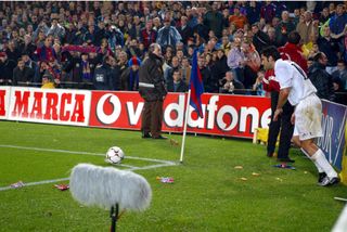Real Madrid's Luis Figo is bombarded with objects as he takes a corner at Camp Nou against former club Barcelona in 2002.