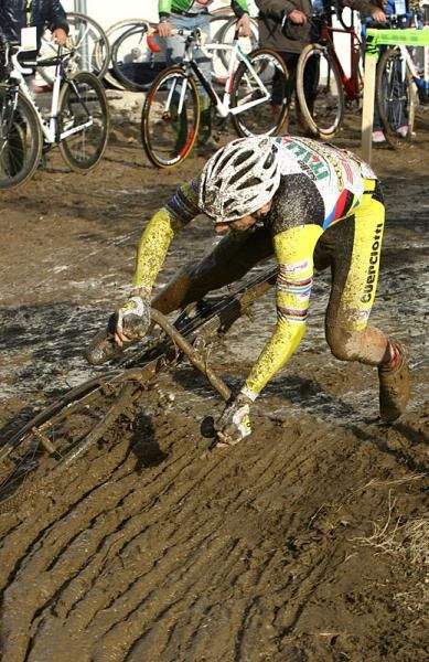 Enrico Franzoi goes down in a crash during a muddy race.