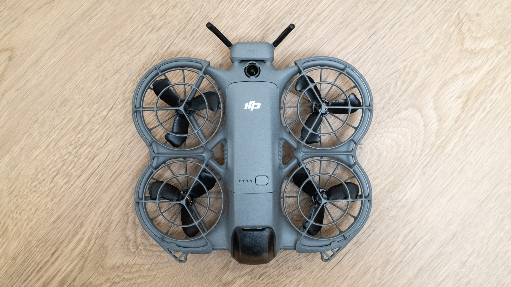 DJI Neo 2 top view on a wooden floor
