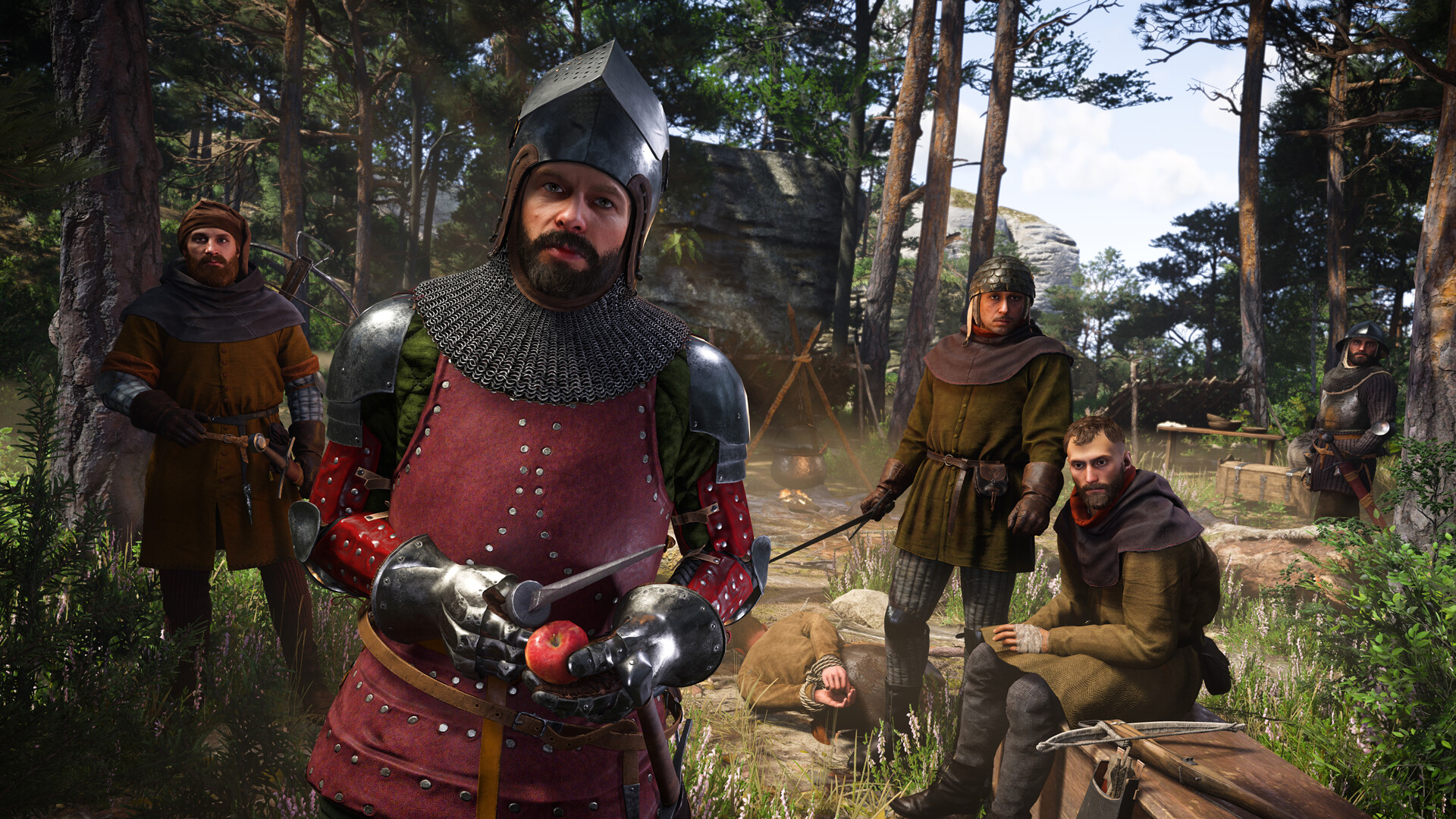 In Kingdom Come Deliverance 2, a man dressed in armor stops player character Henry on the road with a group of bandits