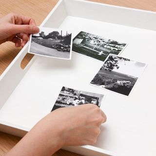 placing photographs on photo tray
