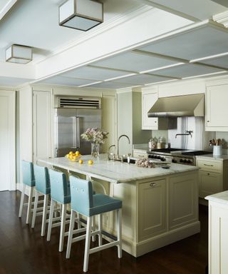 kitchen with cream cabinets and walls with blue stools