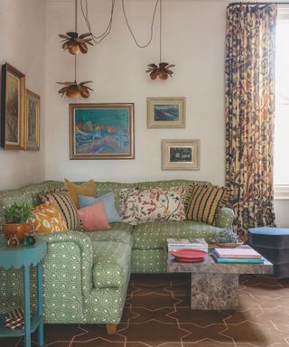 sitting room with tiled floor and patterned sofa