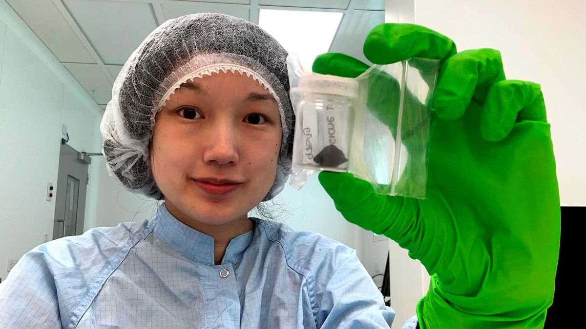 Researcher Queenie Chan holds a sample of the Winchcombe meteorite.