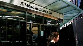 JPMorgan Chase logo above an entrance of two revolving doors at the bank's New York offices