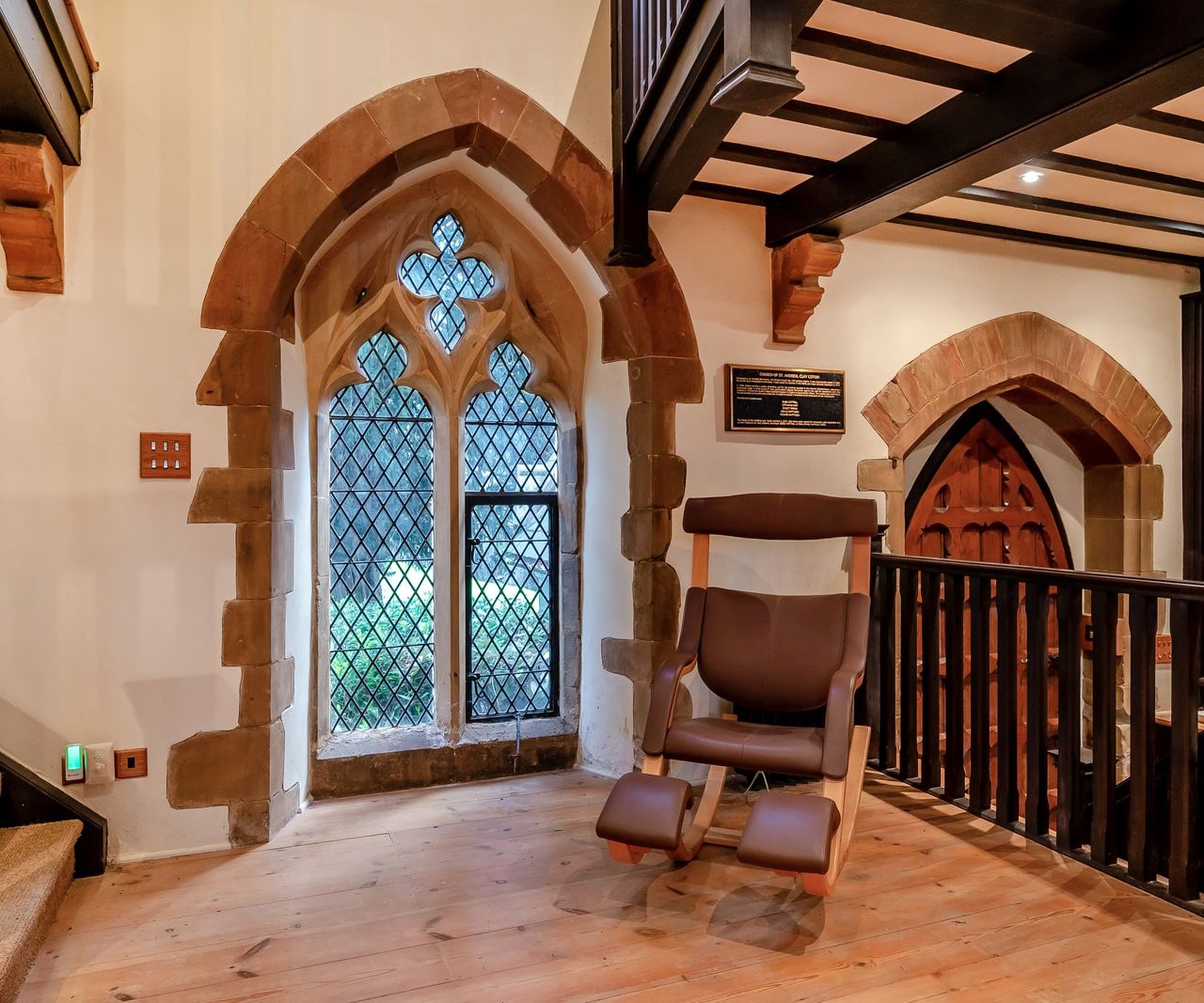 A sitting area next to a stained glass window