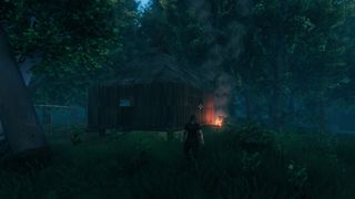 A Valheim base in the woods at night