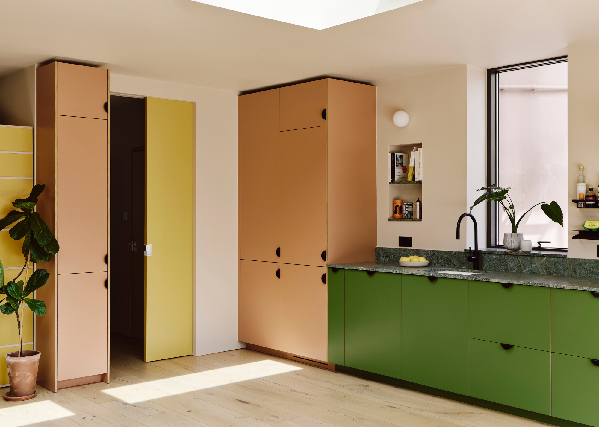 nude, green, and yellow kitchen design with narrow color block cabinetry