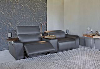 living room with game style chairs, grey leather, drinks trolley, with drink trays and lights, grey rug, grey wall