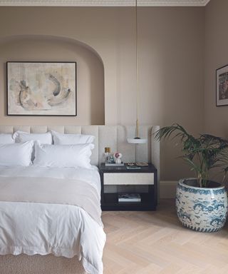 Beige bedroom with palm in blue and white pot