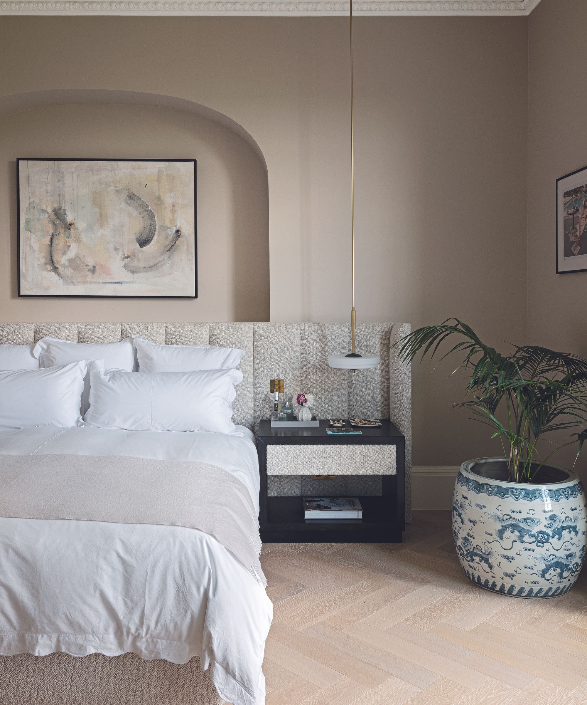 Beige bedroom with palm in blue and white pot