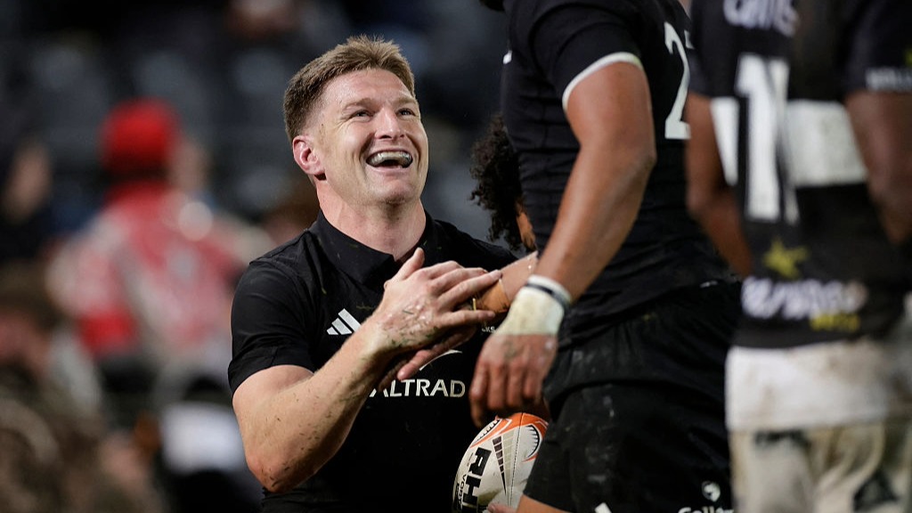 Jordie Barrett, of the All Blacks, celebrates a try with a team-mate.