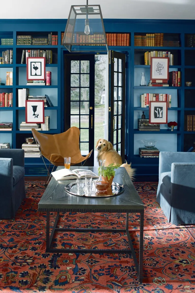 Blue living room with built in bookcase painted in Benjamin Moore Lucern