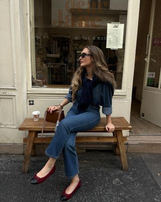 Influencer wears burgundy ballet flats.