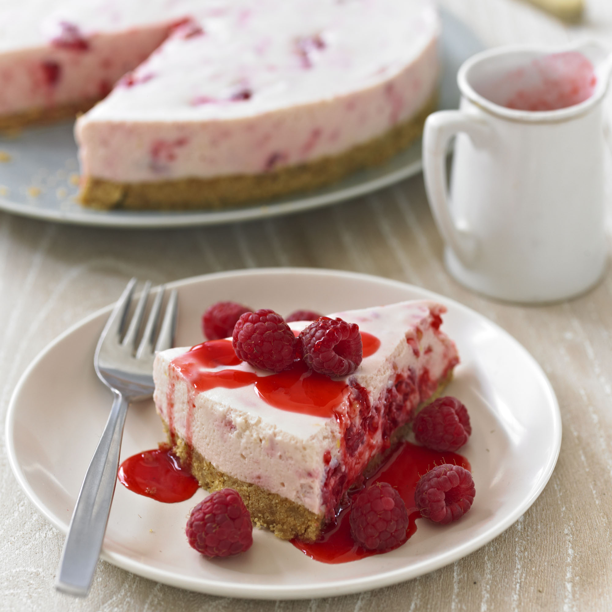 This classic baked cheesecake with fresh raspberries is an indulgent desser...