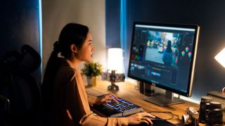 Best Photo Editing software: Young female photographer editing in her home office studio