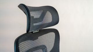 A black mesh OdinLake Ergo PLUS 743 office chair in an office hallway