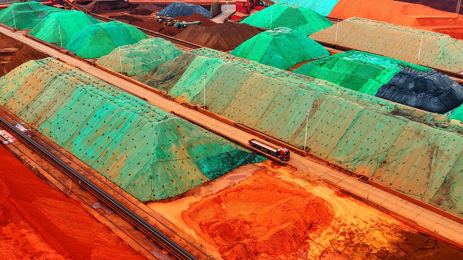 
                                Colorful mounds of imported iron ore are seen at Qingdao Port in Shandong, eastern China
                            