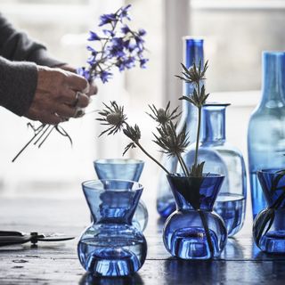 tea light holder and bottle and flowers setting in