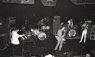 Ex Doors members Ray Manzarek (1939-2013) (left) and Robby Krieger (right) perform live on stage at the release party for Jerry Hopkins and Danny Sugarman's biography of Jim Morrison 'No One Here Gets Out Alive' at the Whisky in Los Angeles in 1980.