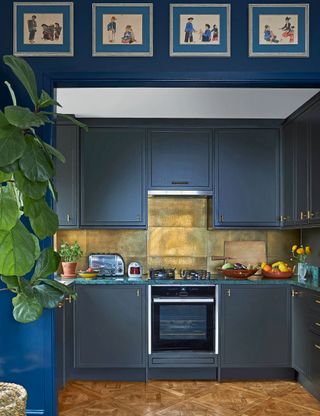 Small kitchen with blue cabinets and metallic wall