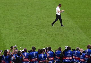 Gareth Southgate, Head Coach of England, looks dejected as he looks at his Runners Up Medal as he leaves the field after the UEFA EURO 2024 final match between Spain and England at Olympiastadion on July 14, 2024 in Berlin, Germany