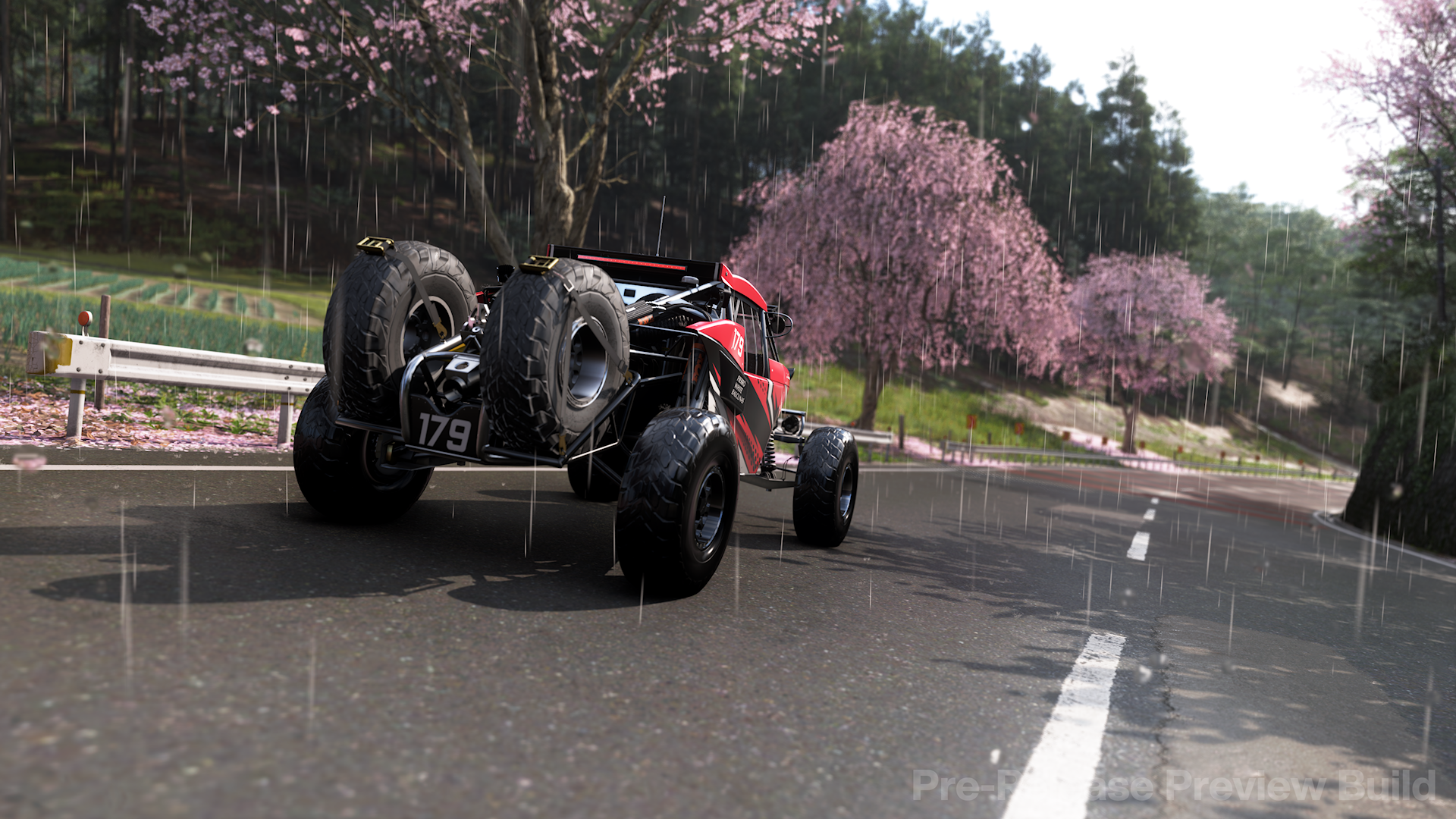 A screenshot from the Forza Horizon 6 preview build showing a car underneath a tree covered in sakura.