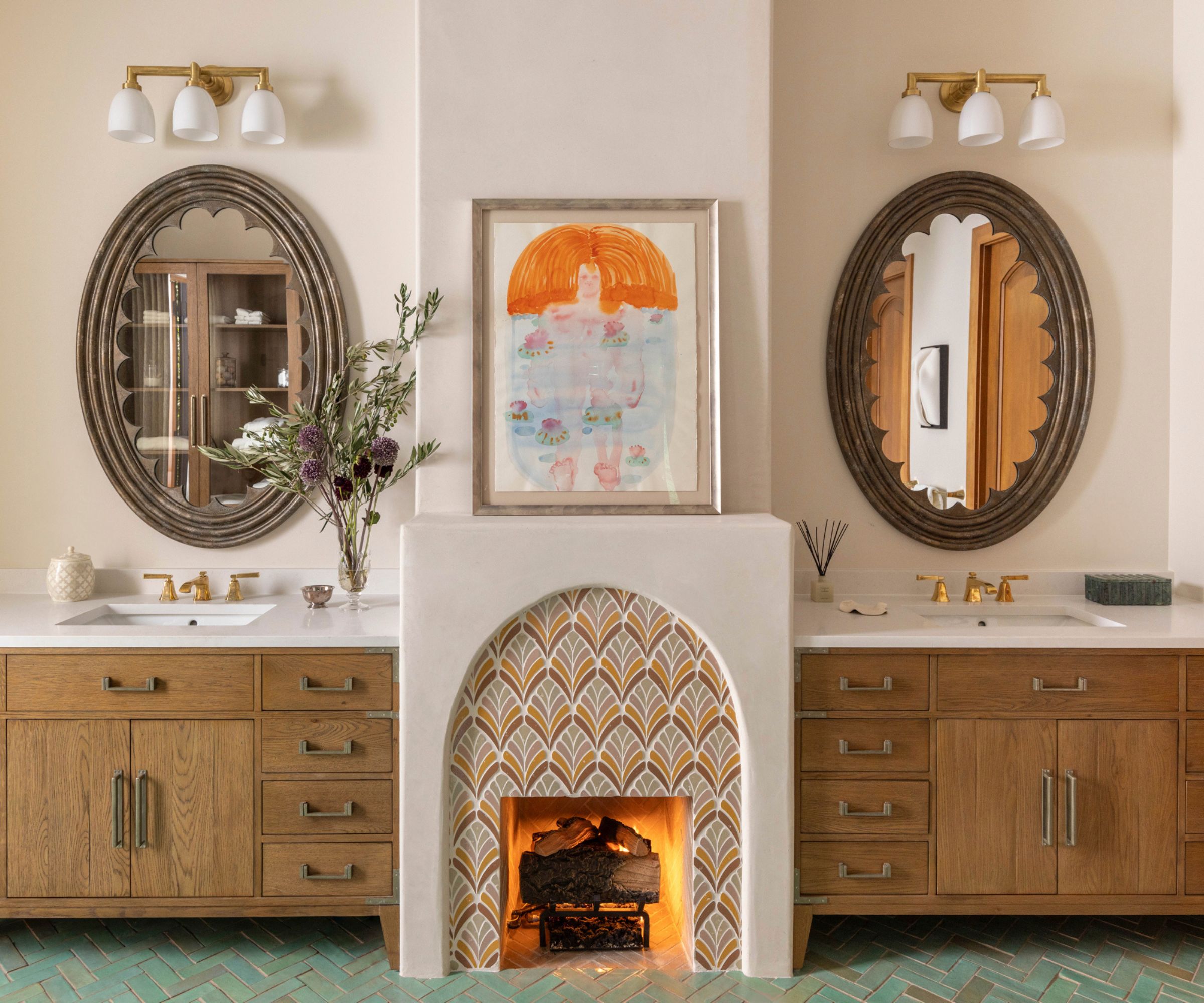 A bathroom with a fireplace at the center and a wooden vanity on either side