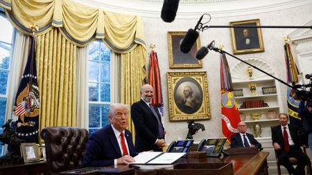 President Donald Trump talks to reporters