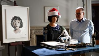 Mike Wooldridge poses with Ai-Da Robot during a photo call for the Royal Institution's Christmas Lectures at The Royal Institution on December 11, 2023 in London, England.