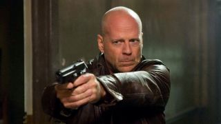Bruce Willis as John McClane holding gun in A Good Day to Die Hard
