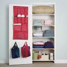white colour cupboard with cloths and pouch