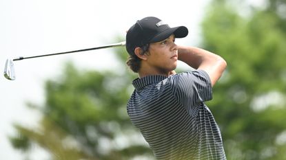 Charlie Woods holds his finish on an iron shot