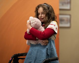 imogen faith reid as natalia grace hugging a stuffed animal in a still from good american family