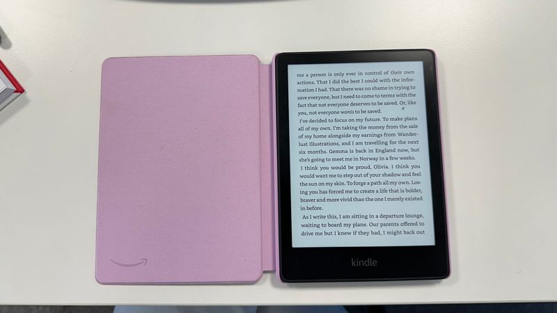 Kindle Paperwhite open on a white desk
