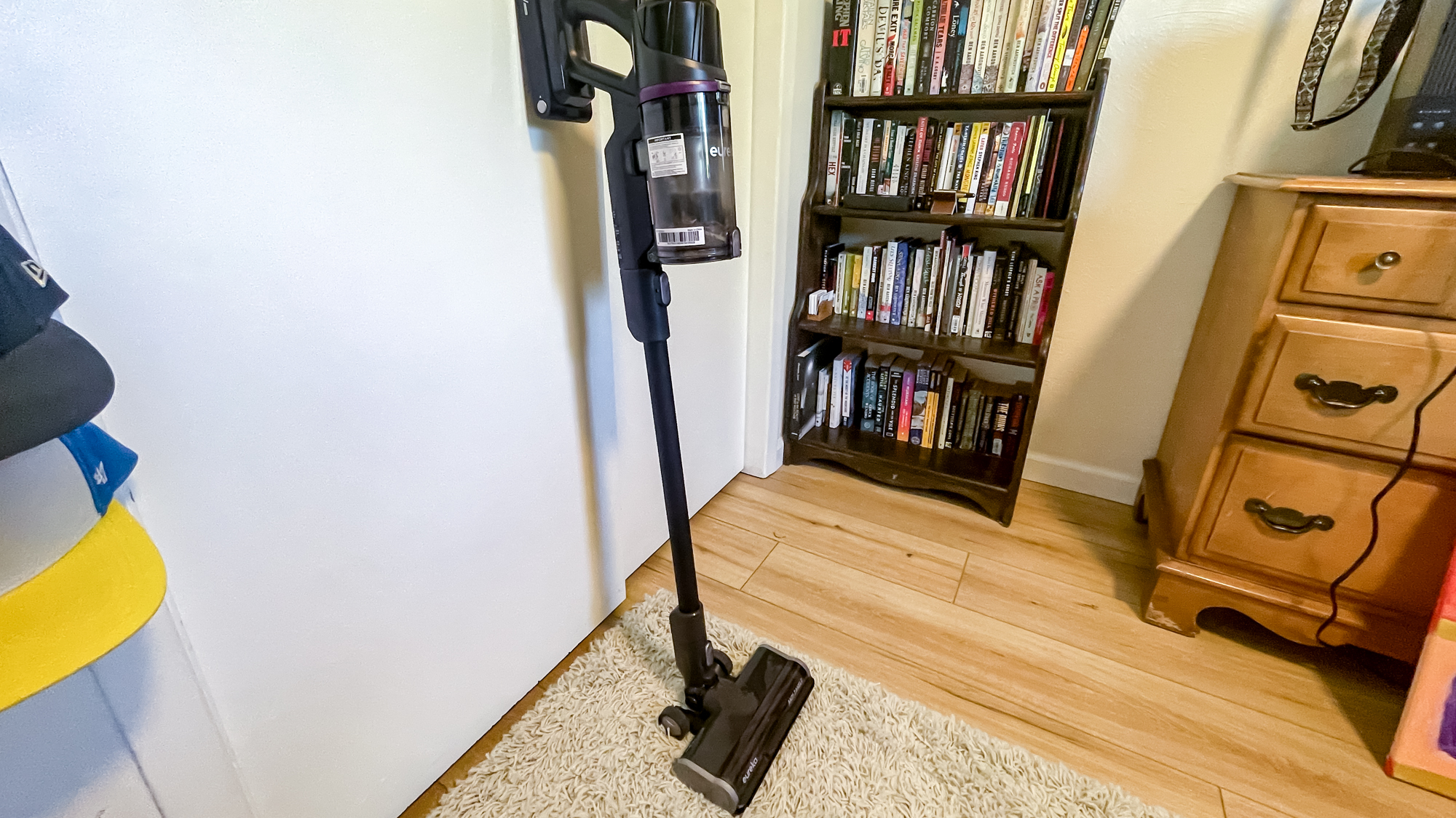 Eureka ReactiSense 440 Cordless Vacuum against wall