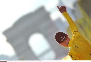 Chris Froome gives a final thumbs up as looks back toward the Arc de Triomphe following the final stage of the 2015 Tour de France.