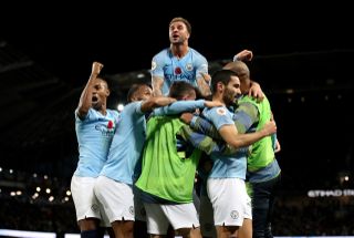 Goalscorer Ilkay Gundogan is mobbed by his Manchester City team-mates, including a leaping Kyle Walker
