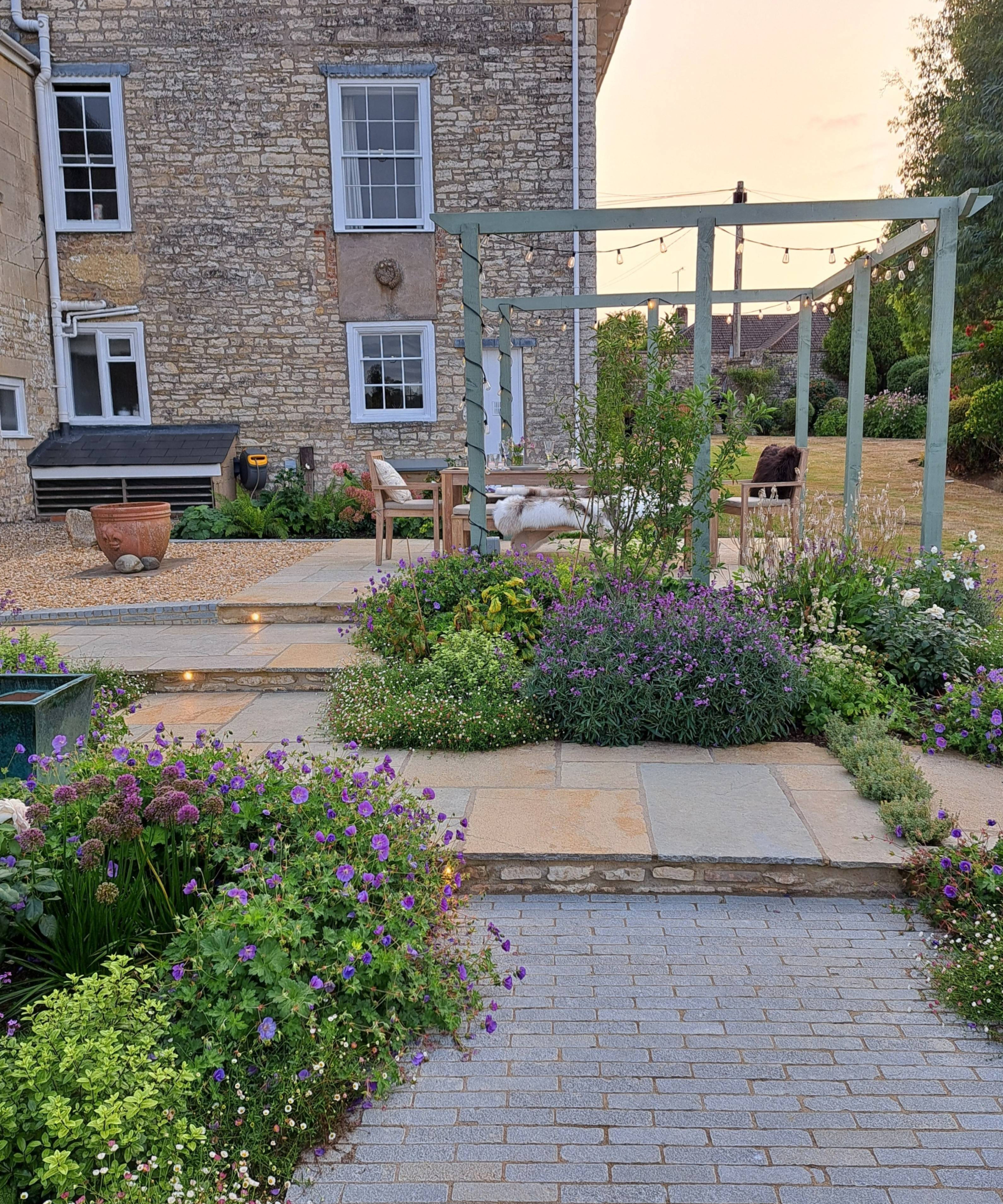 garden with mixed materials patio areas and lots of plants