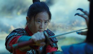 Mulan holds her sword up to Xian Lang